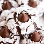 close up of a few chocolate crinkle blossom cookies on a white plate