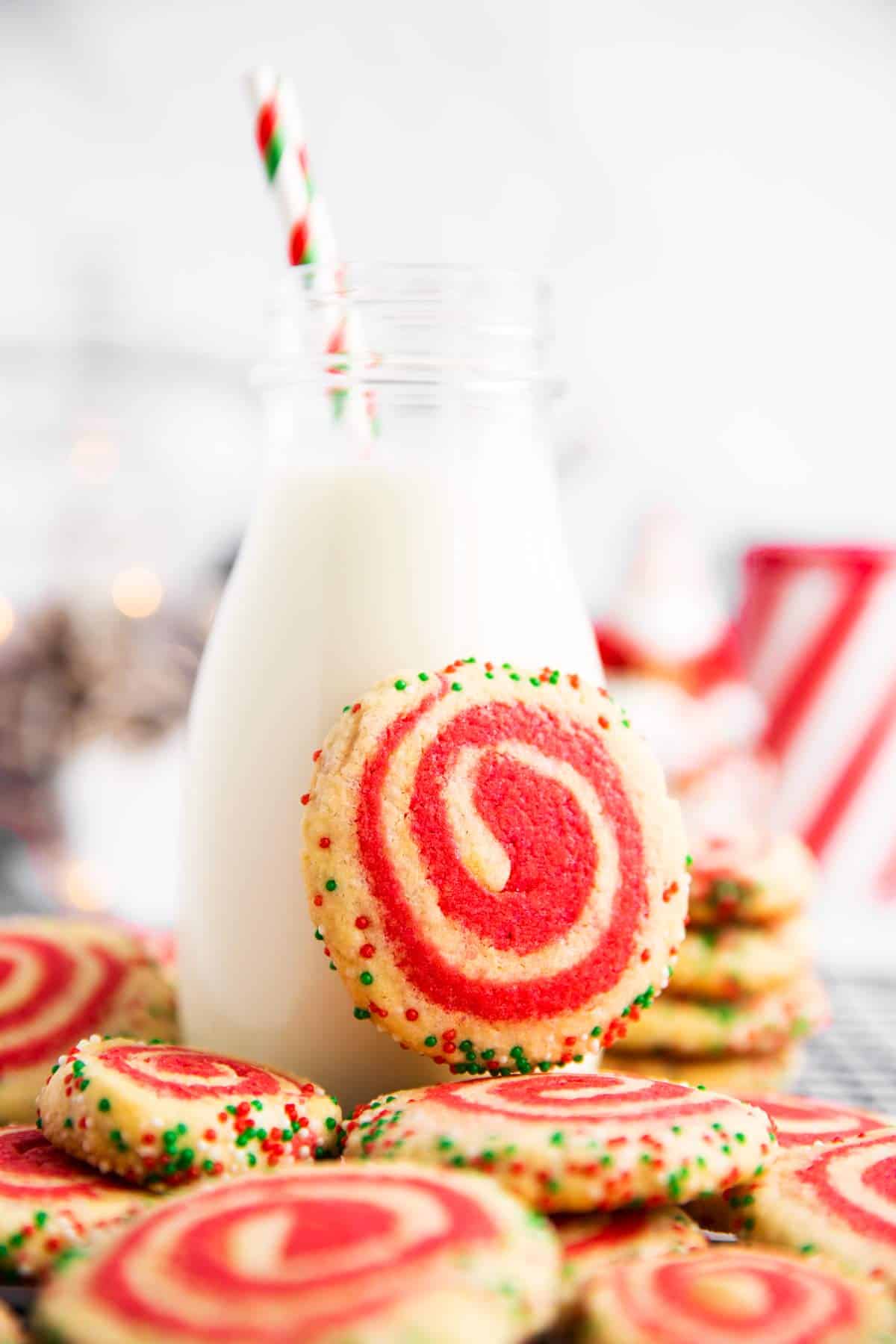 pinwheel cookie leaning against a milk bottle