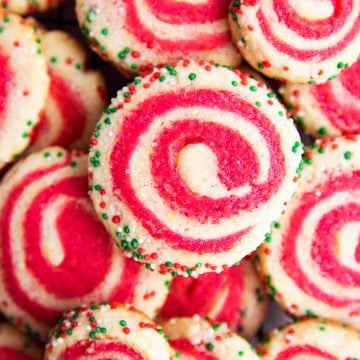 pile of pinwheel sugar cookies in holiday colors