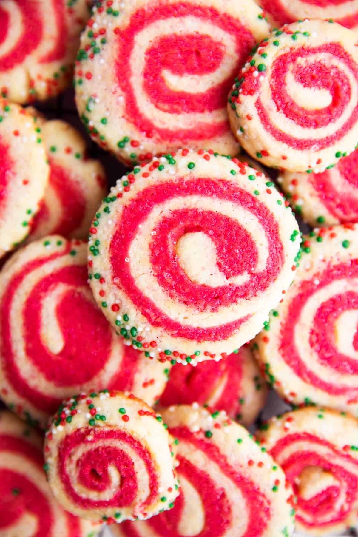 pile of pinwheel sugar cookies in holiday colors