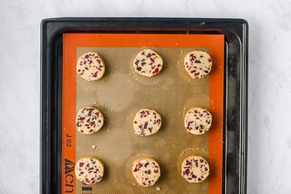 sliced shortbread cookie dough on a lined baking sheet