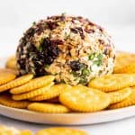 cheeseball sitting on platter with crackers