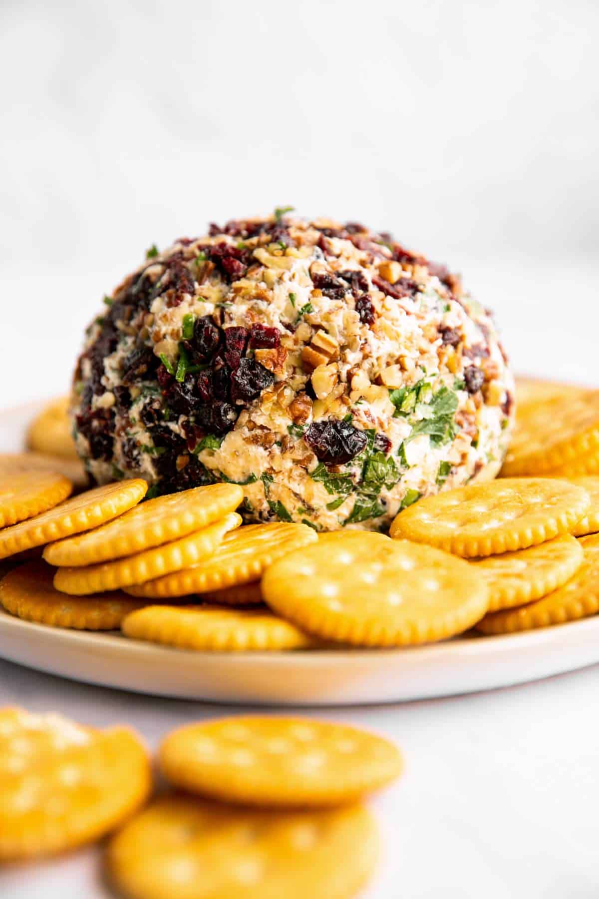 cheeseball sitting on platter with crackers