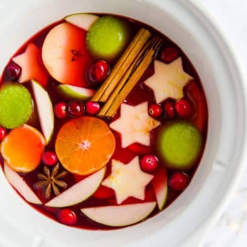 top down view of a white crock pot filled with Christmas punch