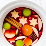 white slow cooker filled with warm Christmas punch