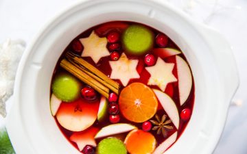 white slow cooker filled with warm Christmas punch
