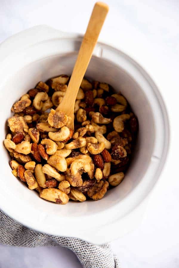 white crock on marble surface filled with nuts