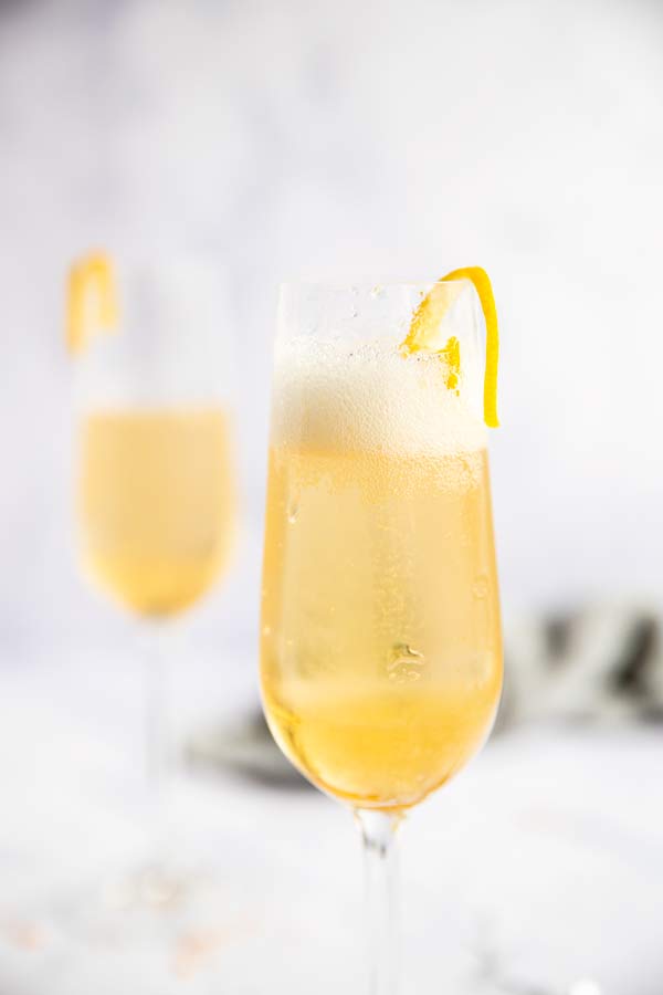 two glasses of st Germain champagne cocktail in a bright light