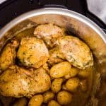 top down view on an instant pot filled with chicken thighs and baby potatoes