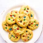 plate with m&m cookies on a white marble surface