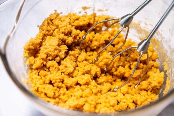 cookie dough for peanut butter cookies in a bowl with beaters