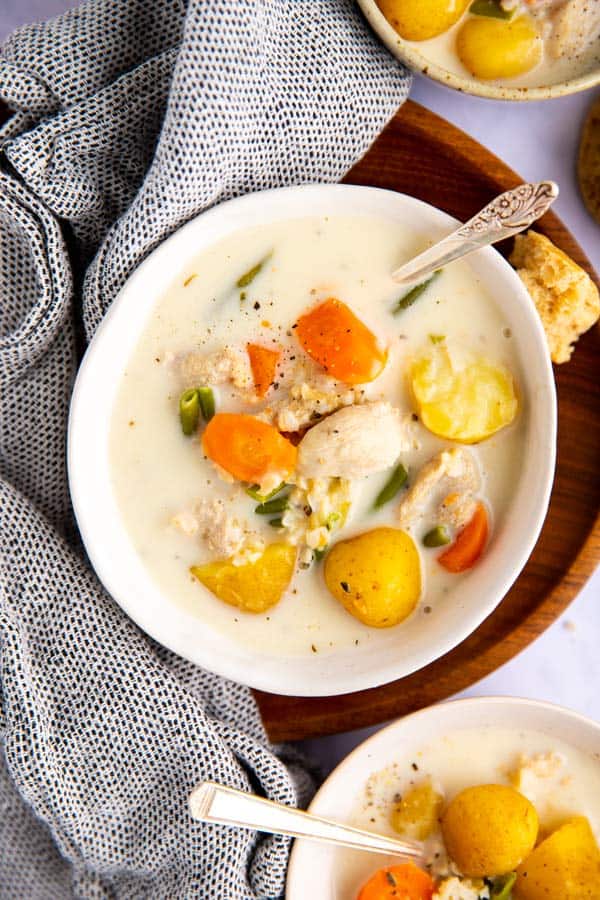 three bowls of turkey soup on a bright surface