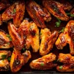 close up photo of a pan filled with sticky glazed chicken wings