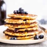 stack of oatmeal pancakes with blueberries on top