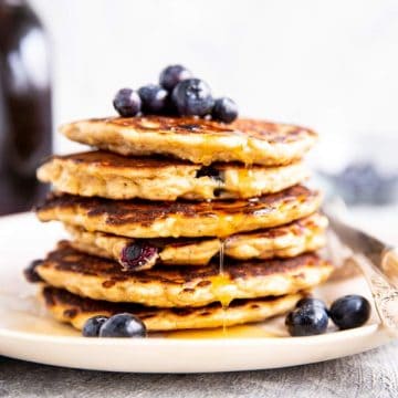 stack of oatmeal pancakes with blueberries on top