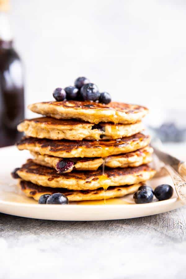 stack of oatmeal pancakes with blueberries on top