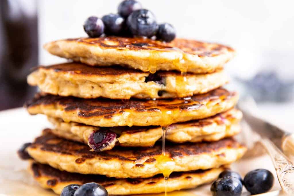 close up photo of a stack of blueberry oatmeal pancakes