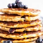 close up photo of a stack of blueberry oatmeal pancakes