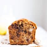 sliced open banana bread with chocolate chips on a wooden board