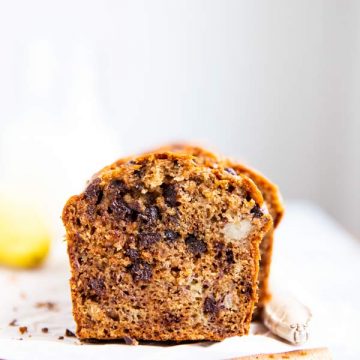 sliced open banana bread with chocolate chips on a wooden board