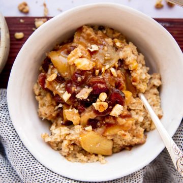three white bowls on wooden board filled with oatmeal