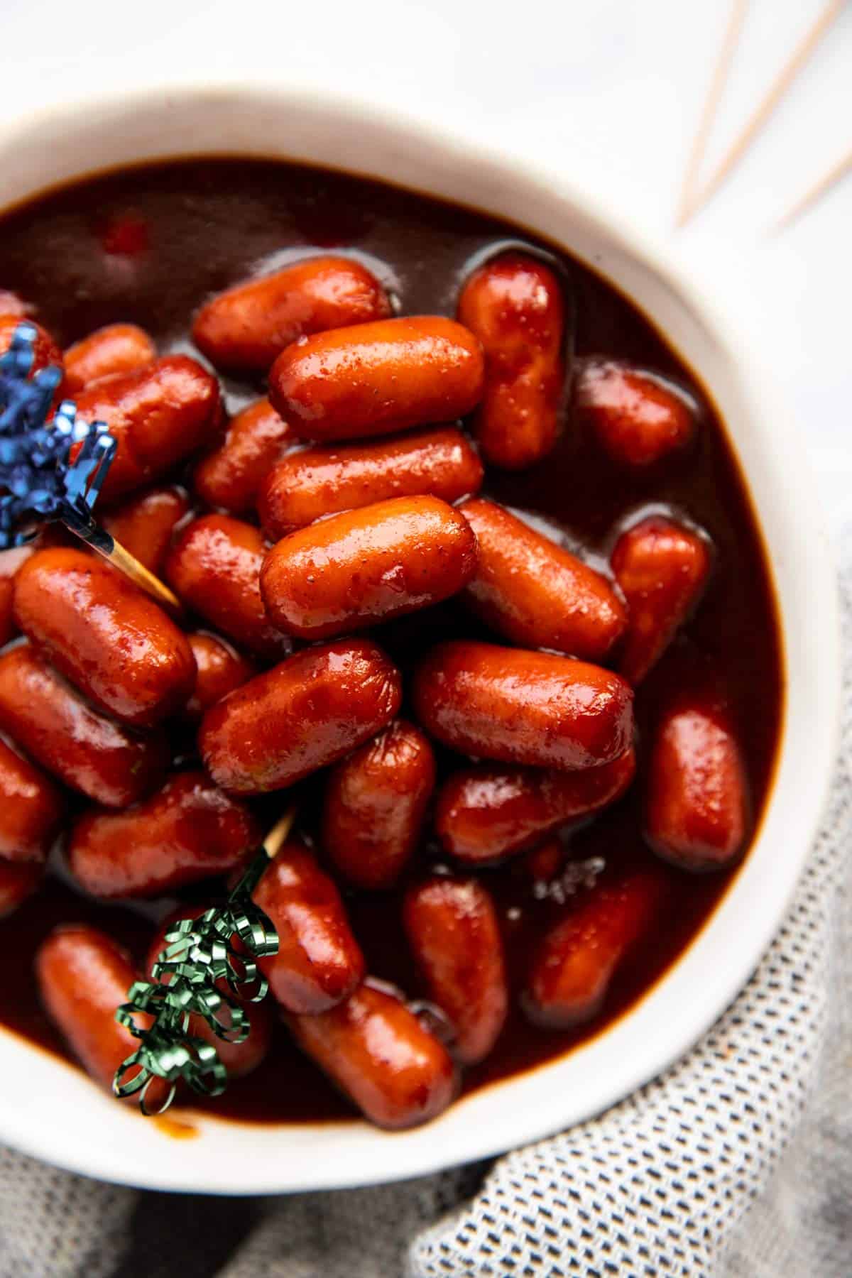 overhead view of white bowl filled with bbq smokies