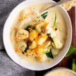 close up photo of a bowl filled with creamy chicken and gnocchi soup