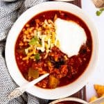 top down view on bowls of turkey chili with sour cream and cheese