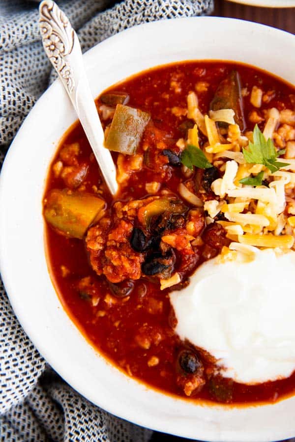 close up view of a white bowl filled with chili