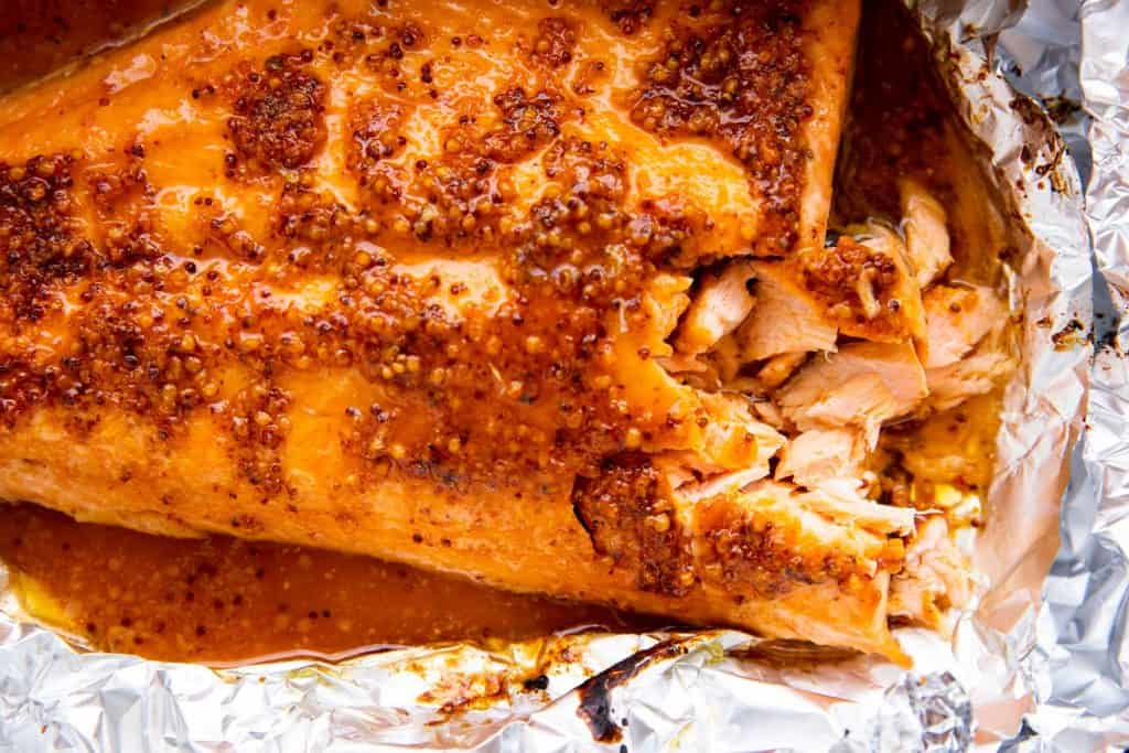 photo of salmon side with maple dijon glaze on a piece of aluminum foil