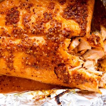photo of salmon side with maple dijon glaze on a piece of aluminum foil