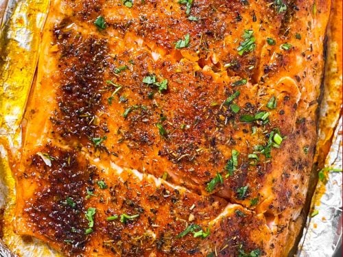 overhead view of oven baked salmon fillet cut into pieces