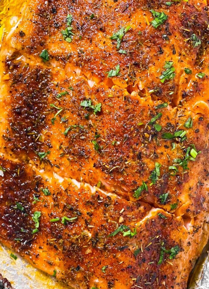 overhead view of oven baked salmon fillet cut into pieces