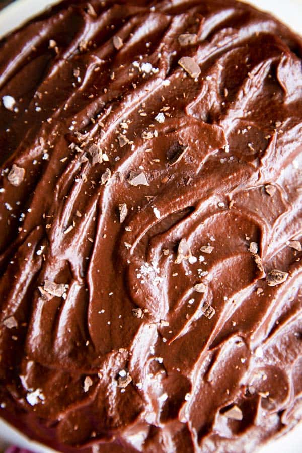 close up top down view on ganache spread over a cake