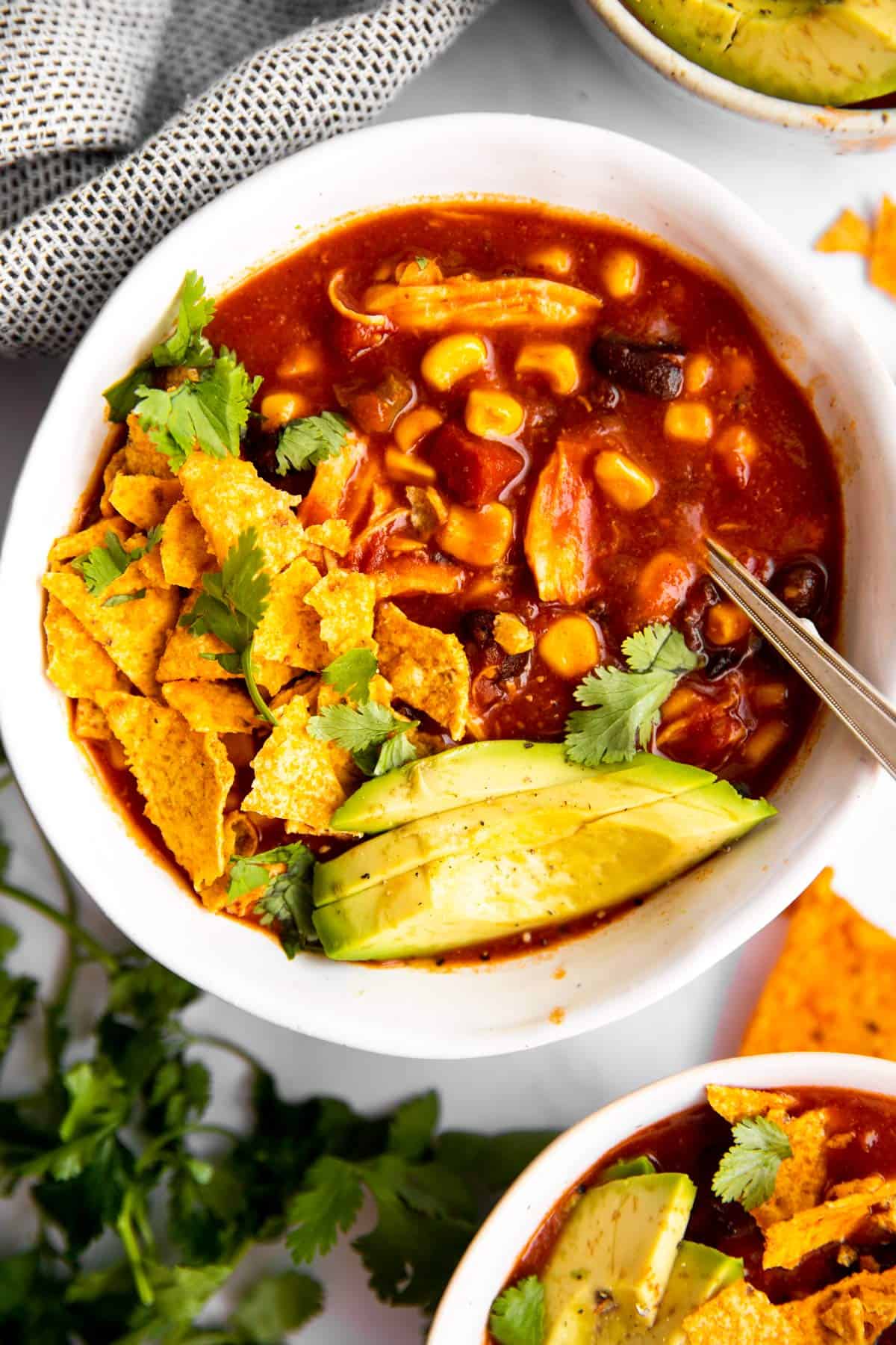 overhead view of white bowl with crockpot chicken taco soup