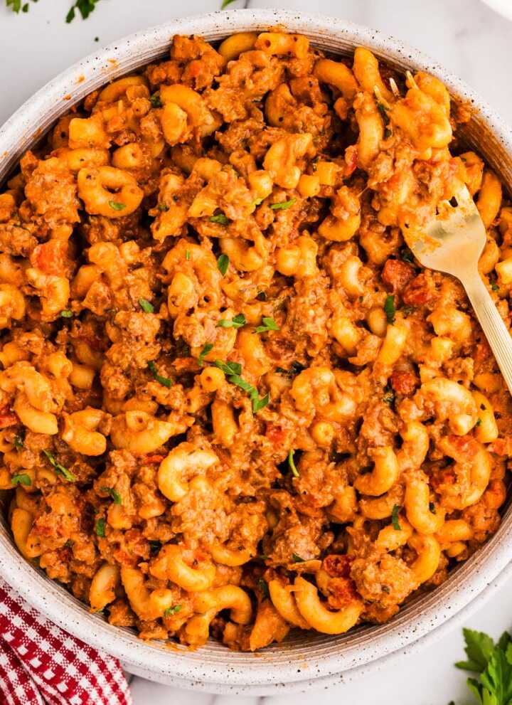 American Goulash in a bowl with a fork stuck in.