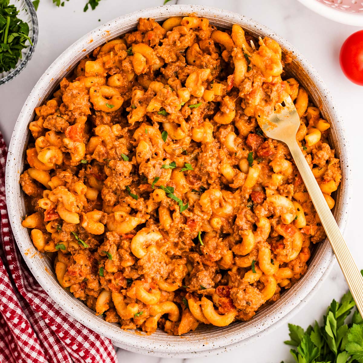 American Goulash in a bowl with a fork stuck in.