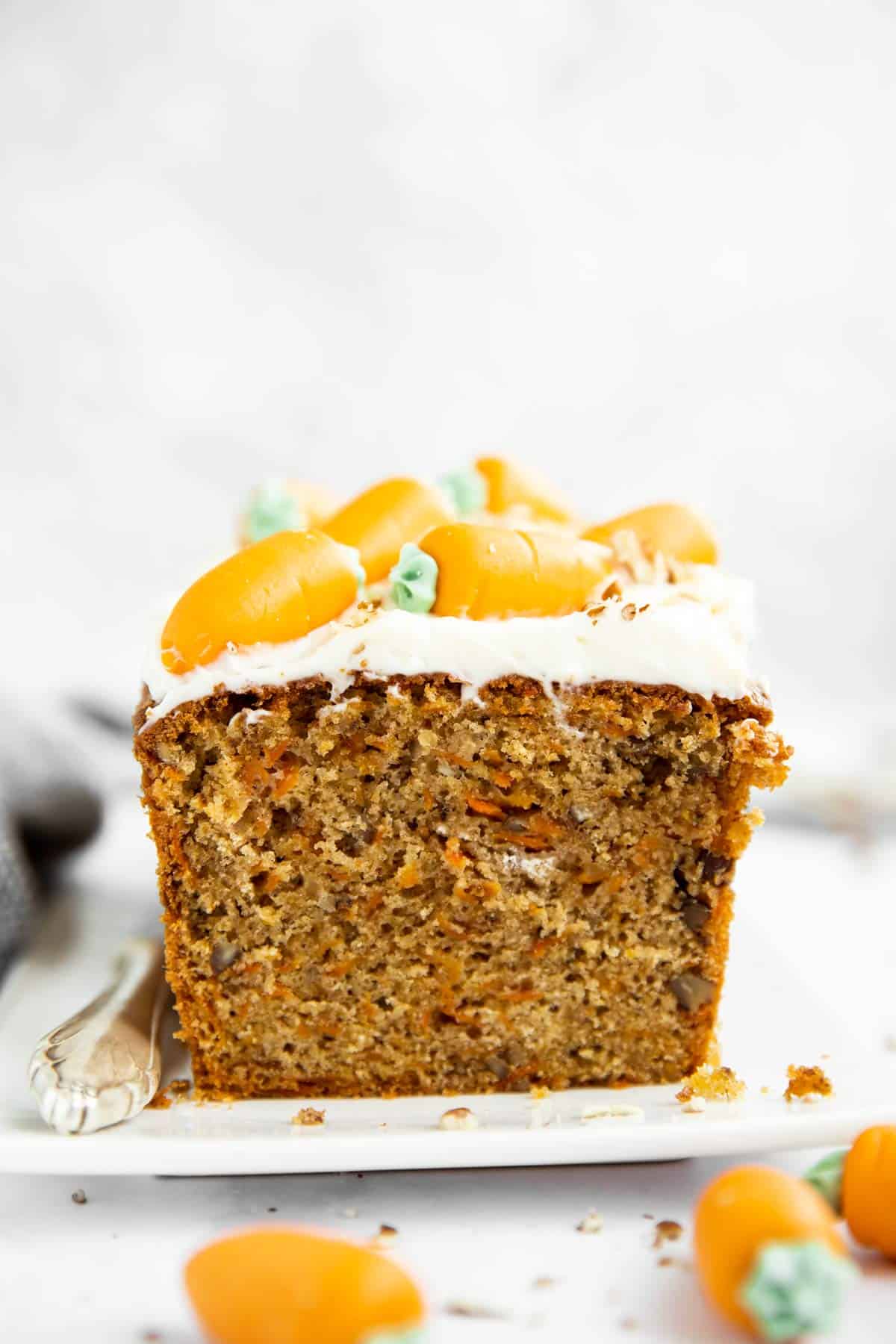 image of sliced carrot cake loaf on a white platter