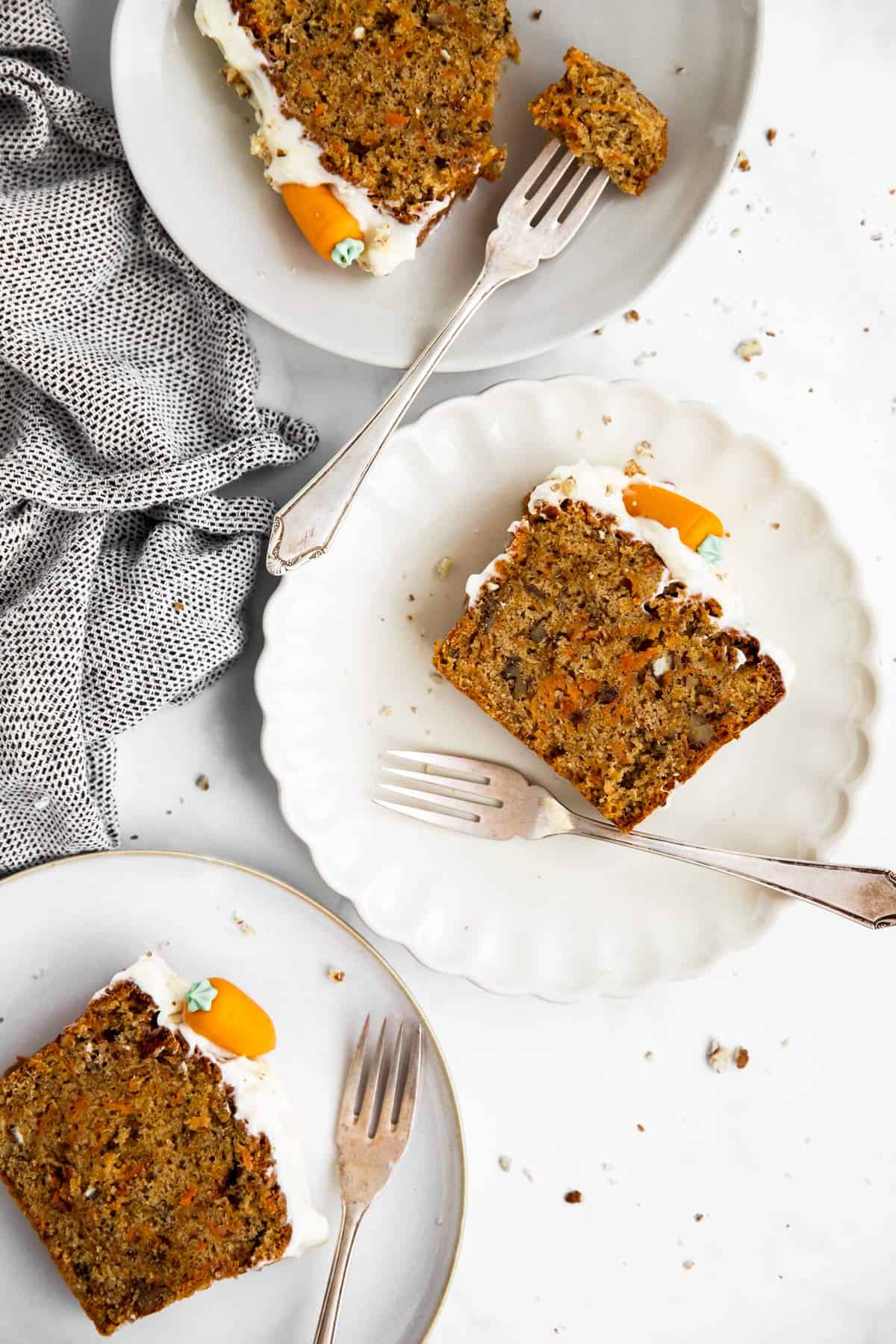 three plates with slices of carrot cake loaf