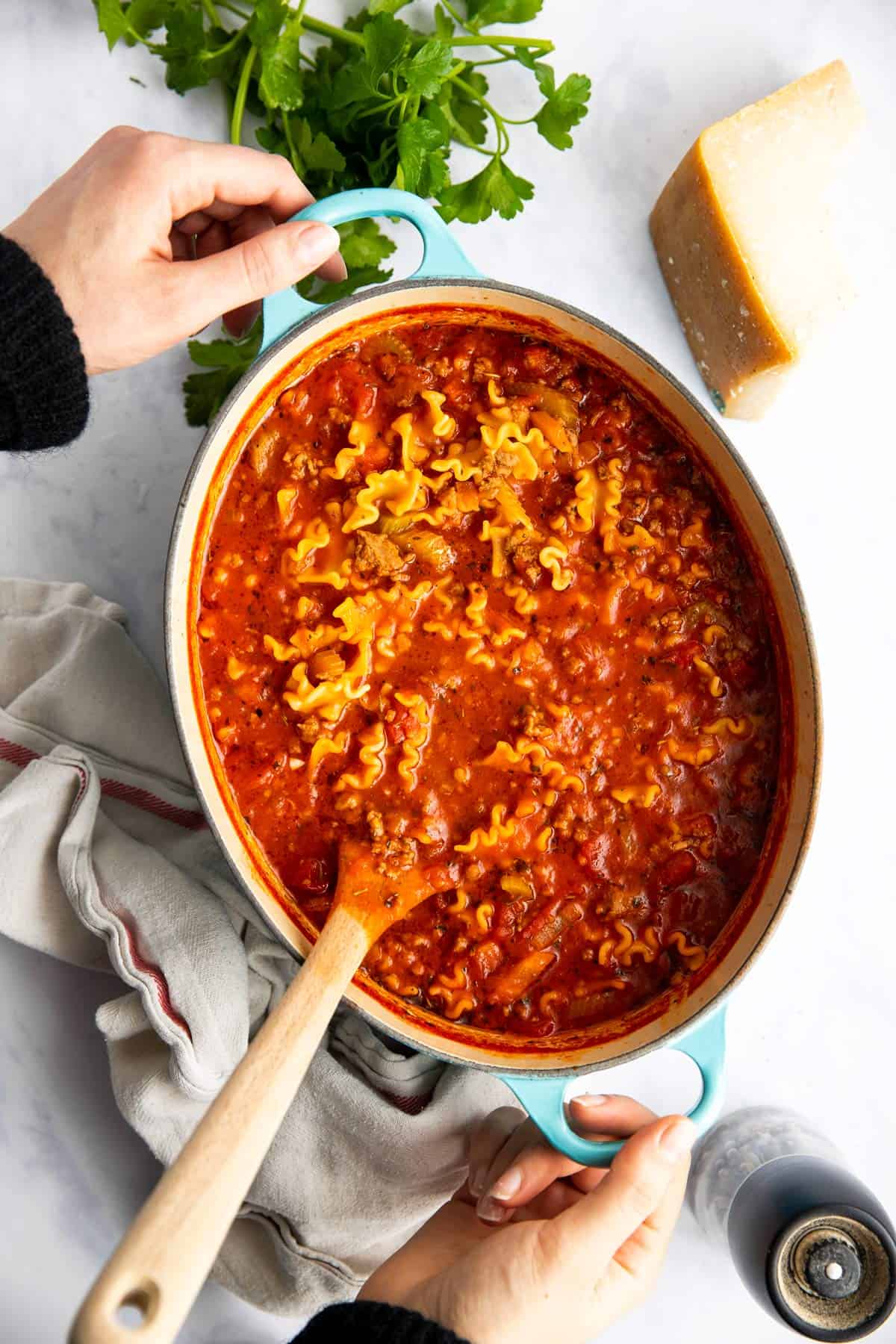 woman holding a pot of lasagna soup