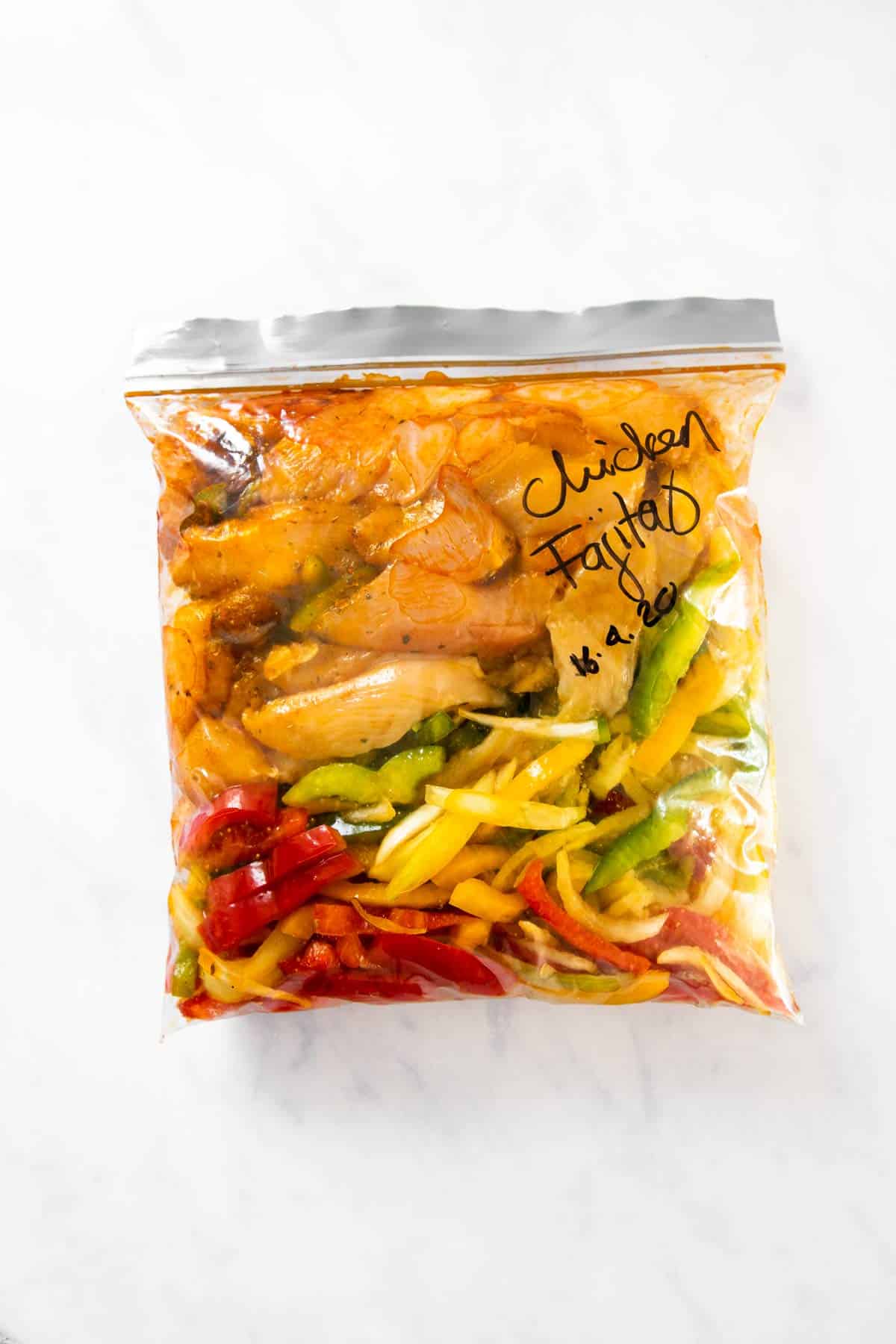 freezer bag filled with ingredients for chicken fajitas