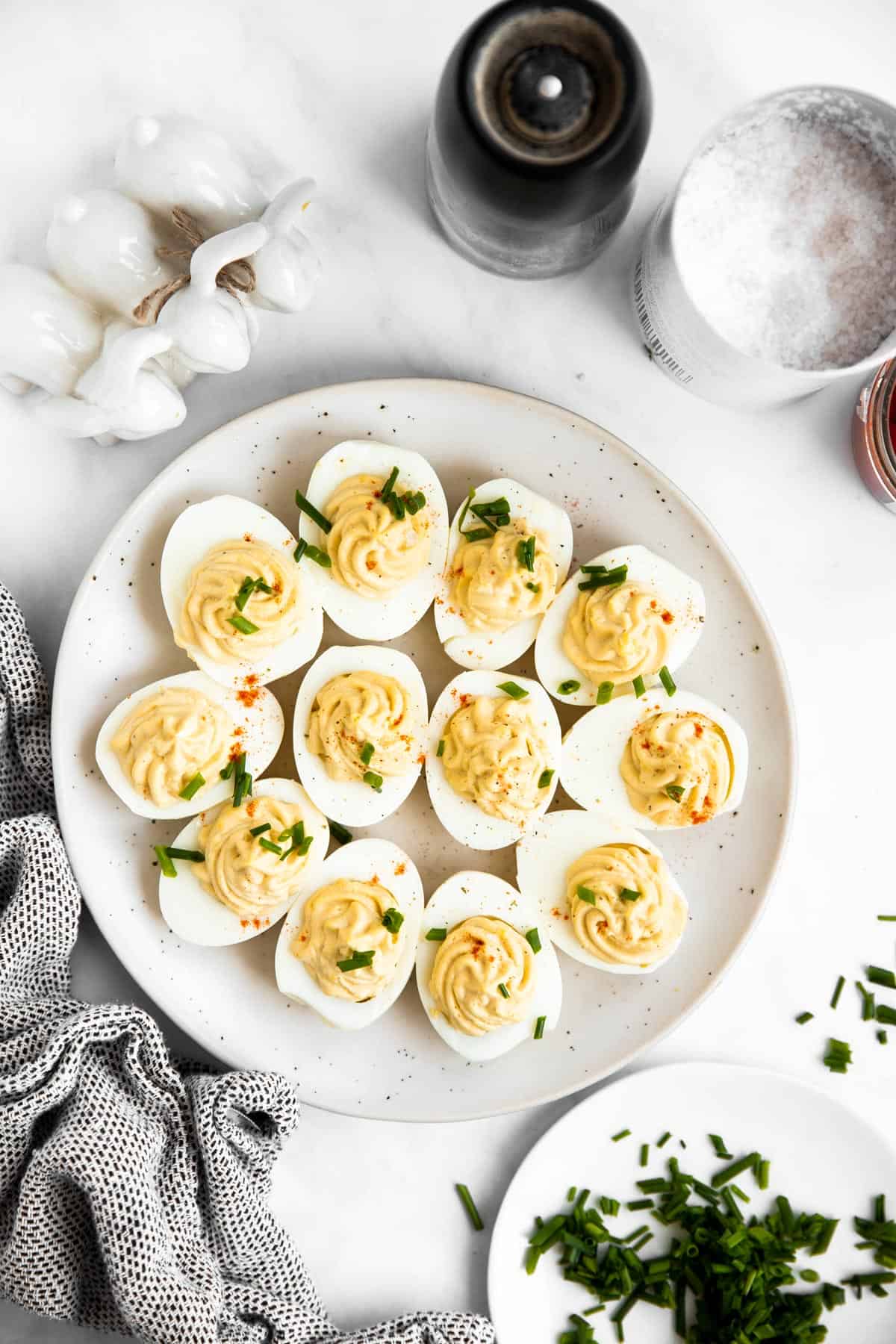 top down view on a white plate filled with deviled eggs