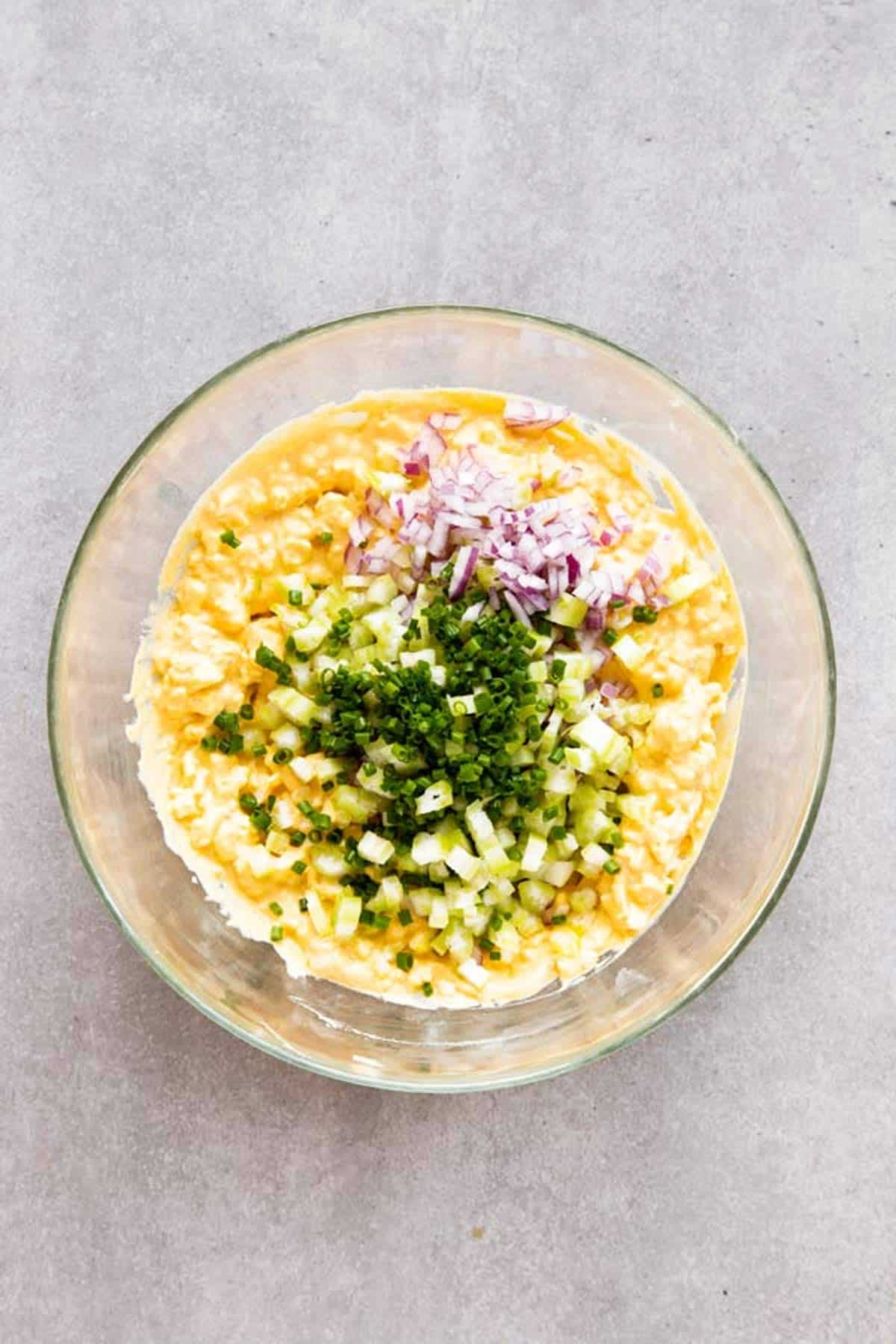 top down view on bowl with ingredients for egg salad