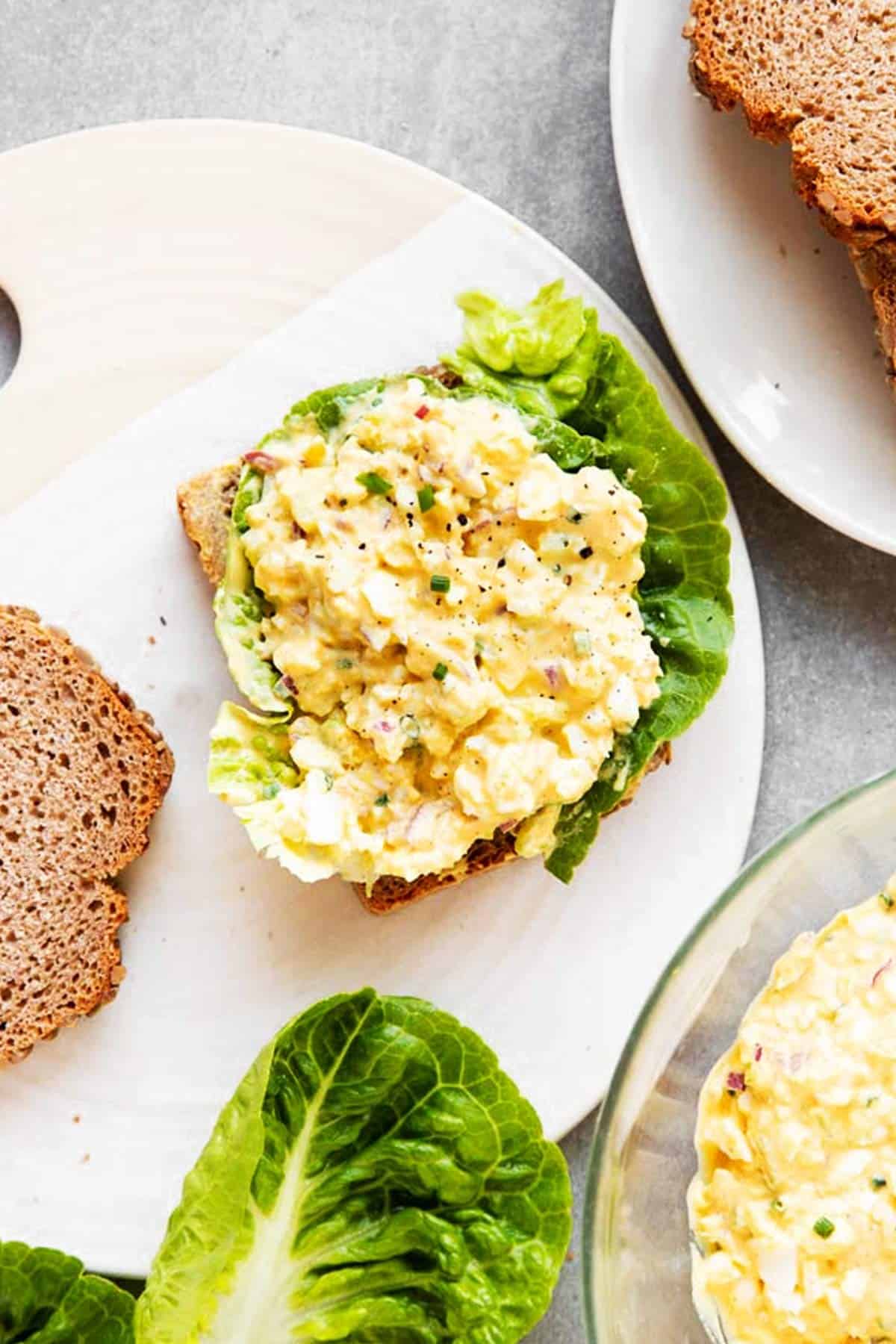 bread with lettuce and egg salad to make an egg salad sandwich