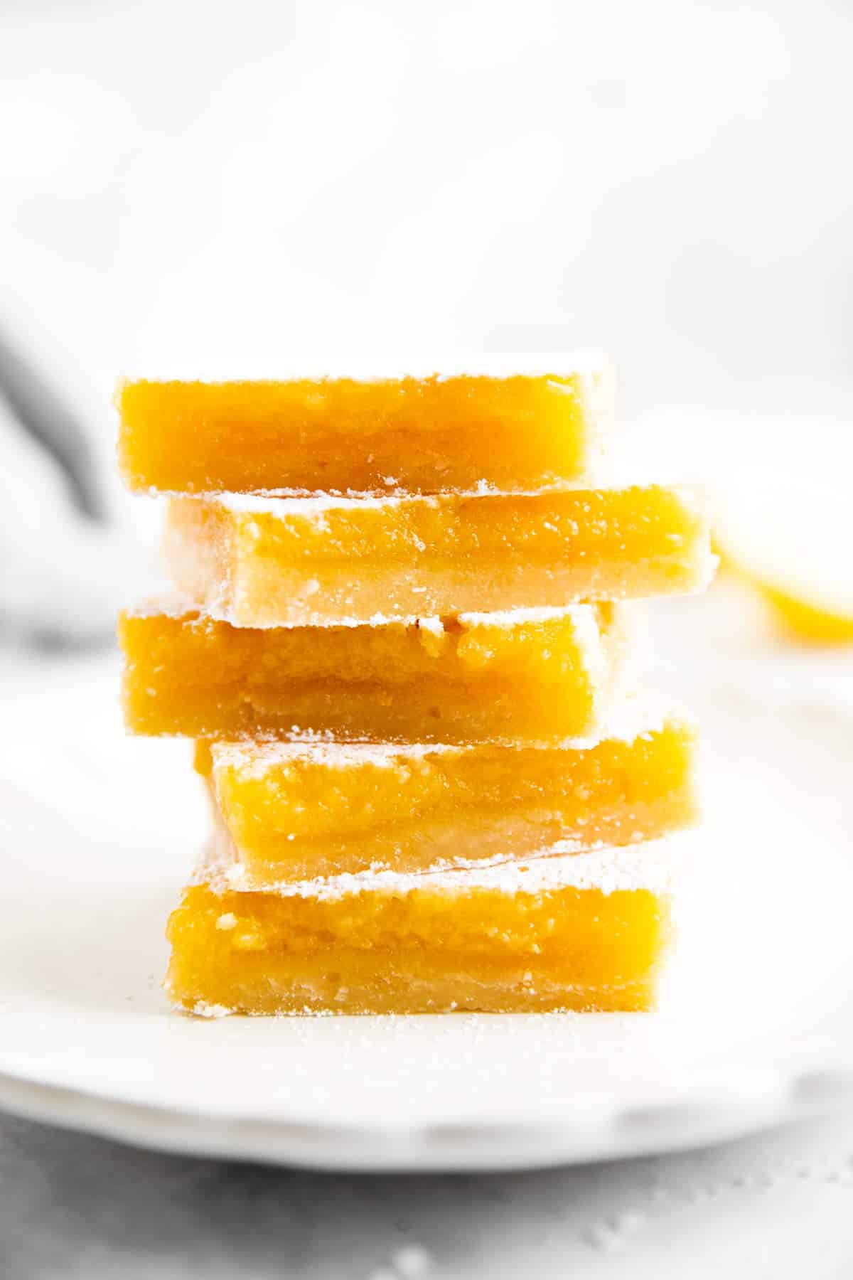 stack of lemon bars on white plate