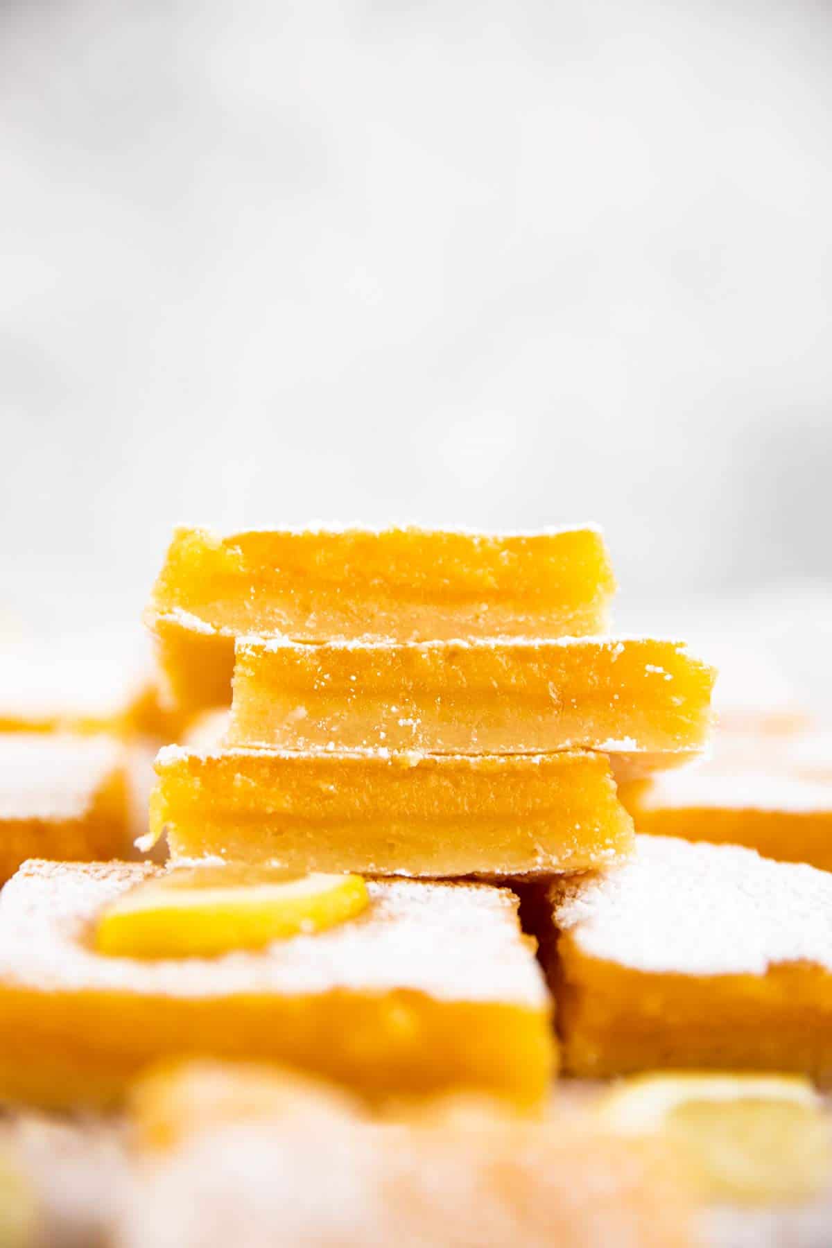 stack of lemon bars on more lemon bars