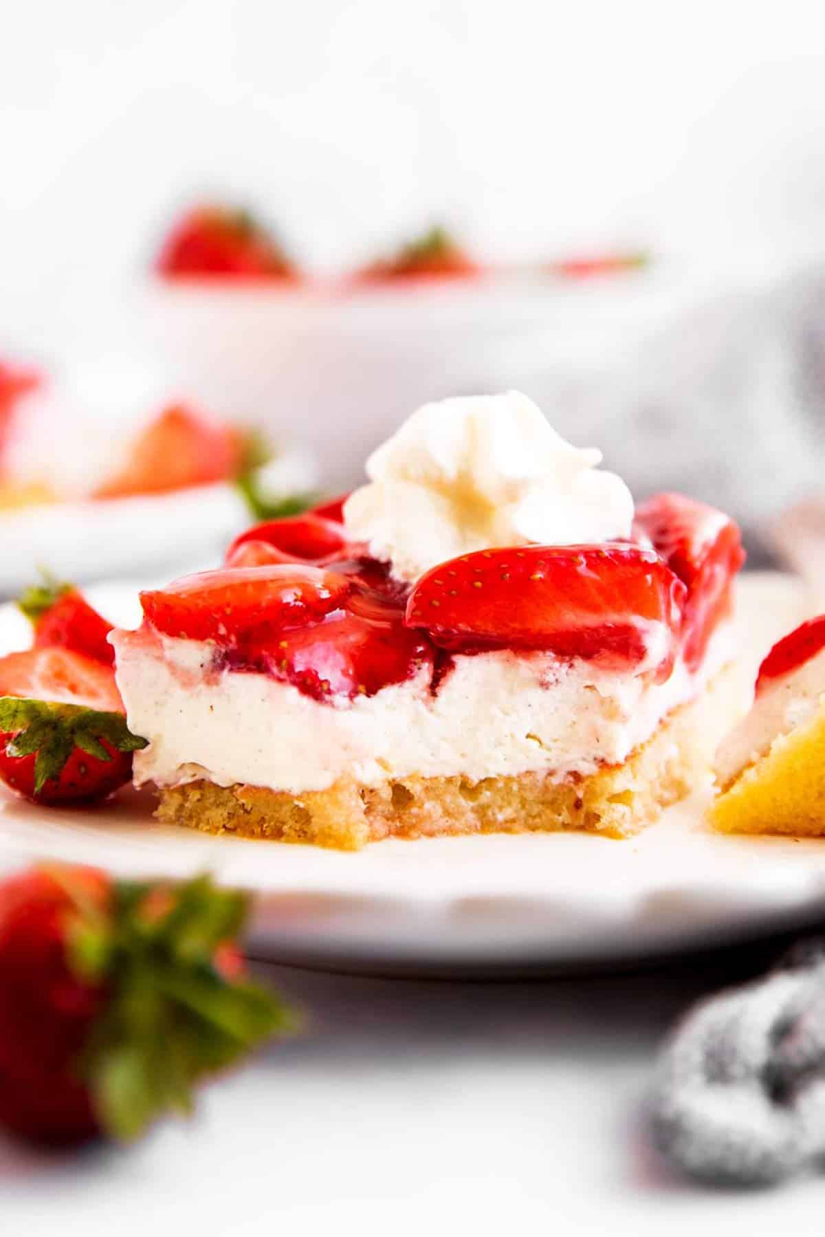 close up photo of slice of fresh strawberry cake with bite taken out