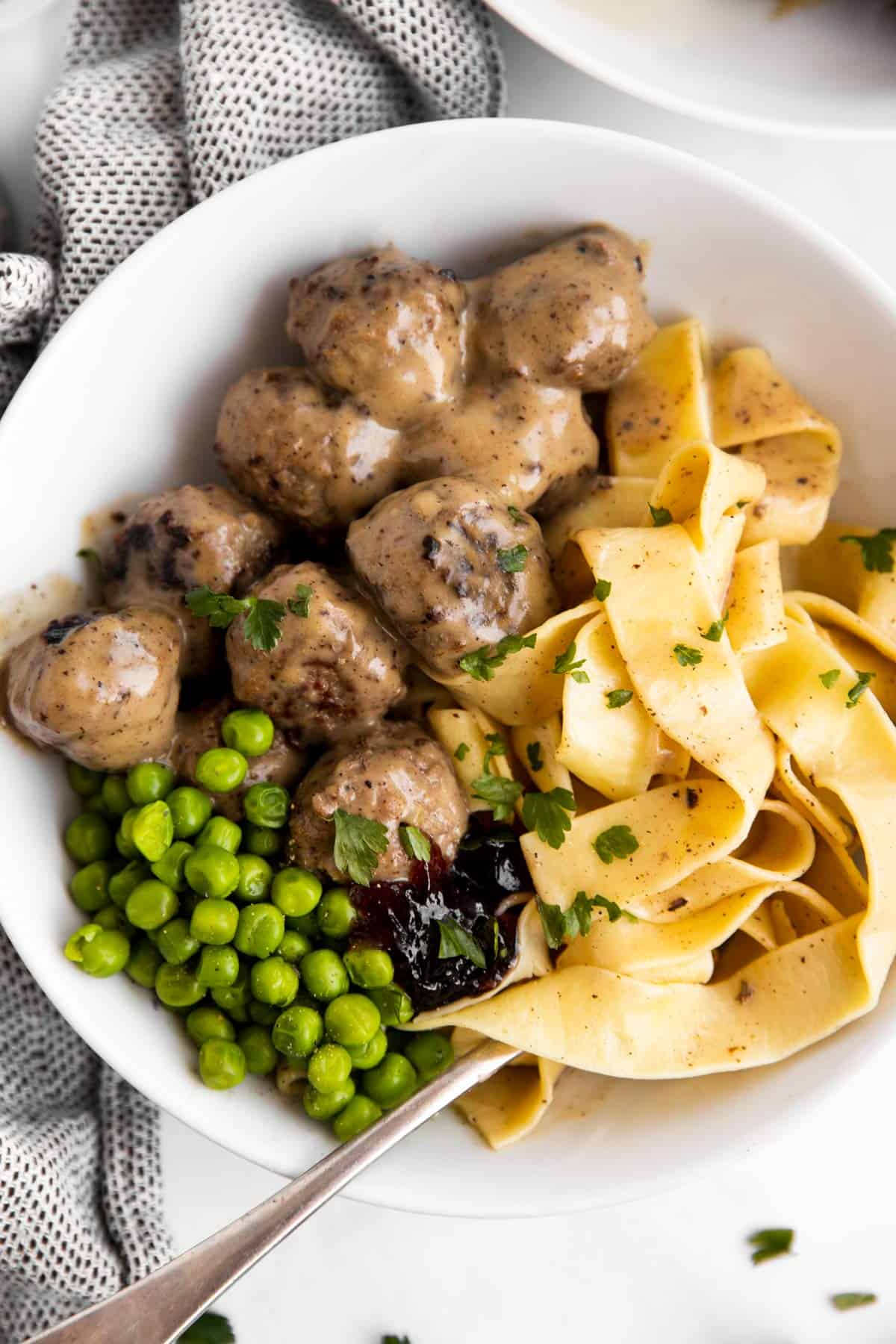 close up photo of a plate with noodles and meatballs