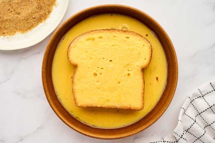 French Toast in bowl with egg wash.