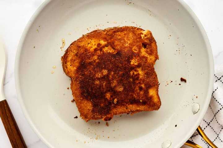 Fried French toast in skillet.